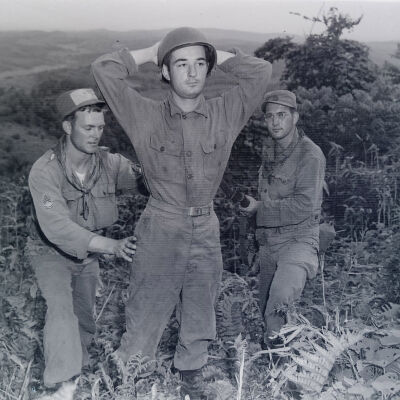 Soldiers searching "prisoner" during war game