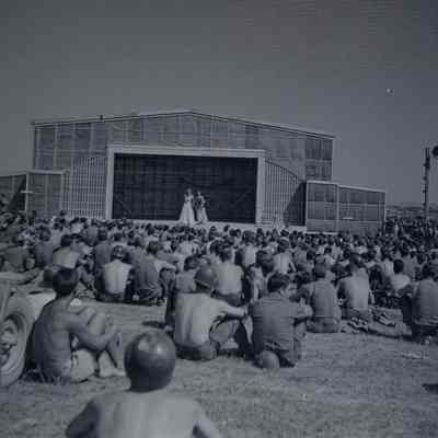 Soldiers watching entertainers on stage