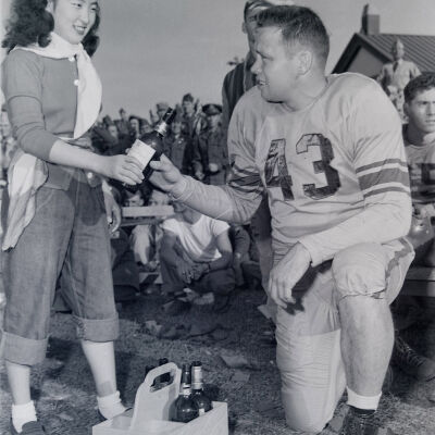 Japanese "Water Girl" handing drink to football player