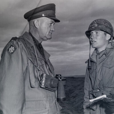 General Styron talking with soldier during beach landing practice