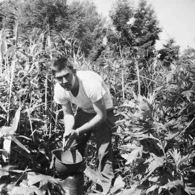 Soldier using his steel pot to wash his hands