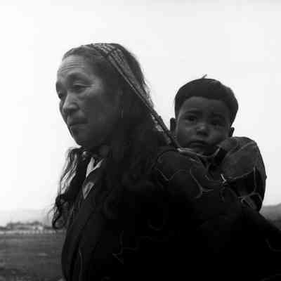 Woman with small child on her back