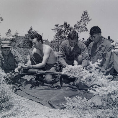Group of soldiers working on a bazooka