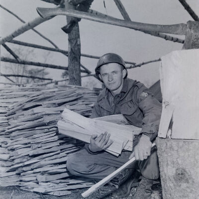 Soldier collecting split wood