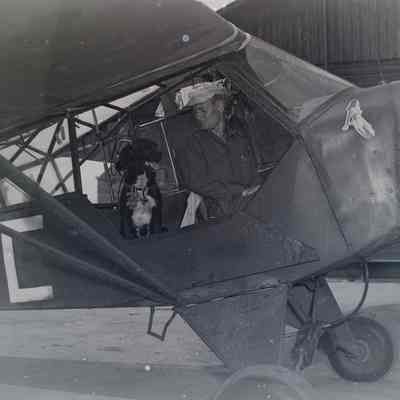 Soldier with a dog in light aircraft