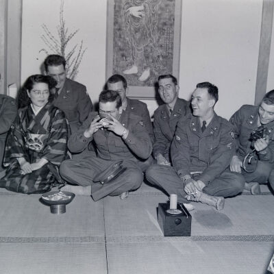 Group of soldiers drinking tea with a Japanese hostess