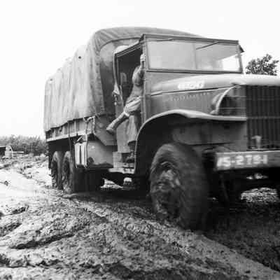 Truck driving through deep mud
