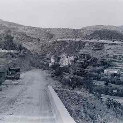Destroyed vehicles on the side of a road