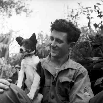 Soldier holding a small dog