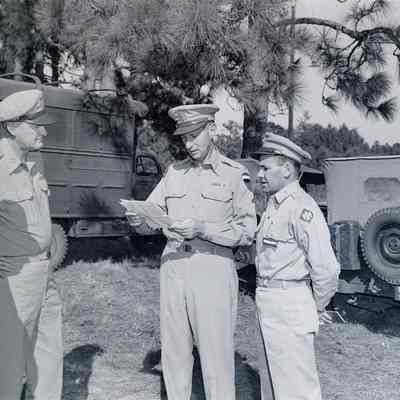 Generals Mark Clark and James Styron at a field meeting with other officers