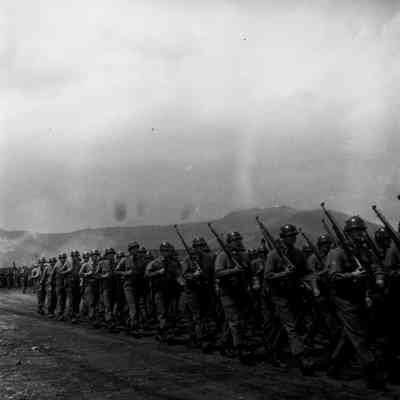 Soldiers marching with shouldered rifles