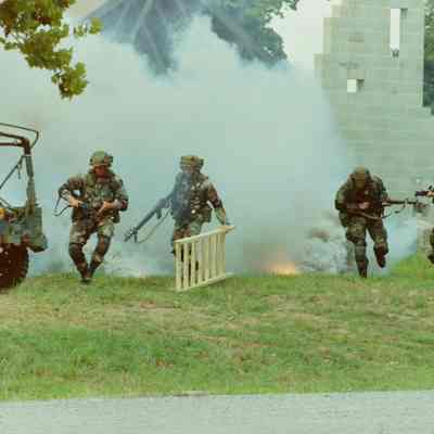 Soldiers using smoke as cover in training village