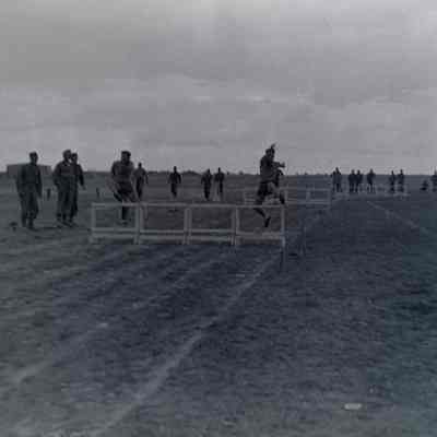 Soldiers running high hurdles