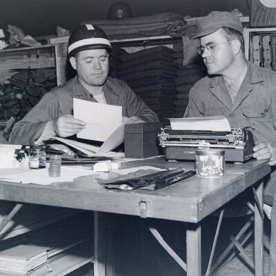 Clerk and officer in supply room