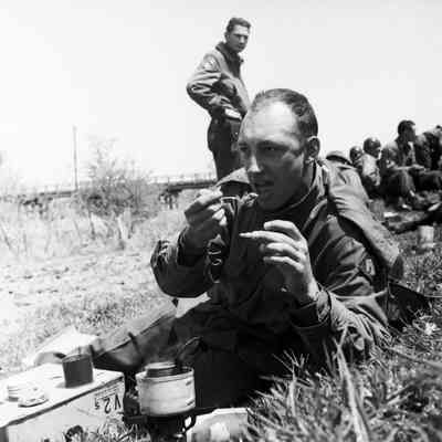 Soldiers eating along the roadside