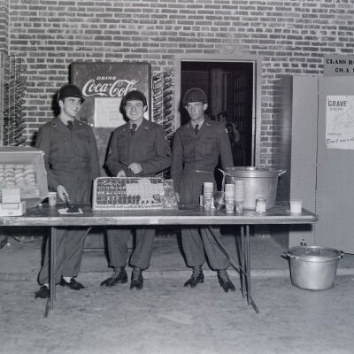 Soldiers serving cake and refreshments in an armory