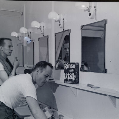 Two soldiers washing up in barracks latrine