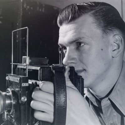 Soldier holding a Speed Graphic camera