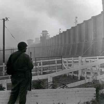 Soldier standing guard at prison wall