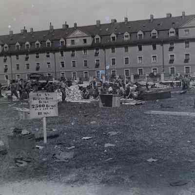 Soldiers and German prisoners constructing bunk beds