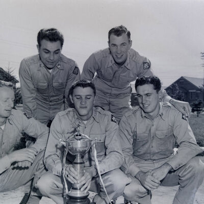 Soldiers with a baseball trophy