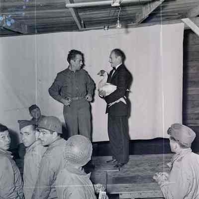 Humphrey Bogart and another entertainer on a makeshift stage