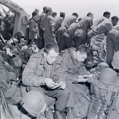 Soldiers with field gear on ship's deck
