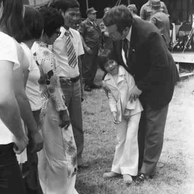 Govenor David Boren meeting a refugee family from Vietnam