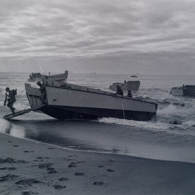 Soldiers stepping off a landing craft