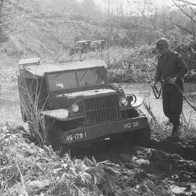 Truck being towed out of stream crossing