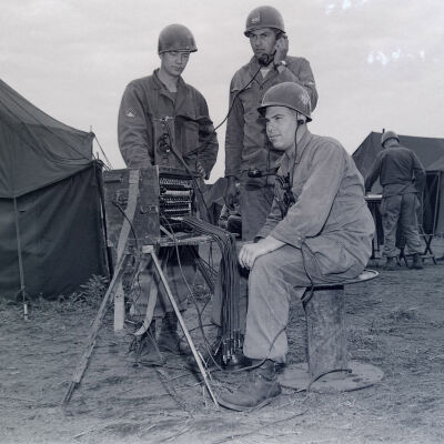 Soldiers around a field telephone switchboard