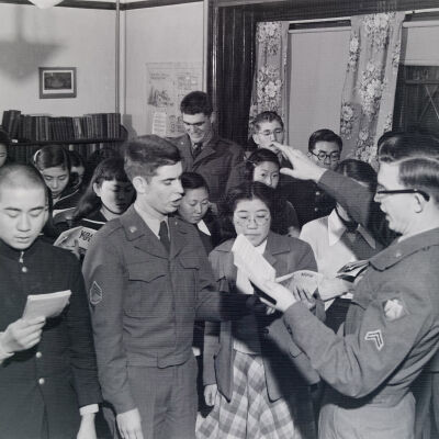 Soldiers and Japanese civilians singing together