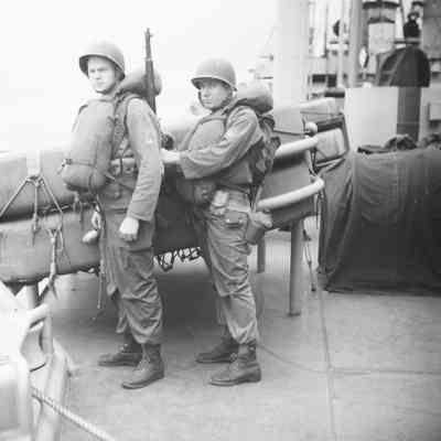 Soldiers checking each other's life vests