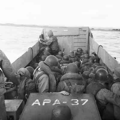 Soldiers landing on beach from landing craft