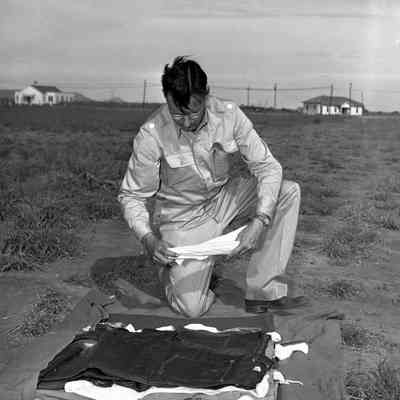 Soldier examining a stack of clothing