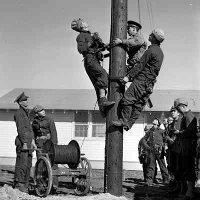 Lineman trainees practice stringing commo wire