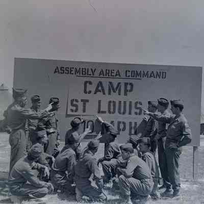 Soldiers in front of Camp St. Louis sign