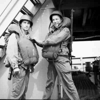 Soldiers checking each other's life vests