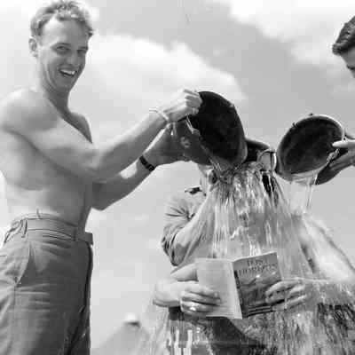 Soldiers dumping water on friend