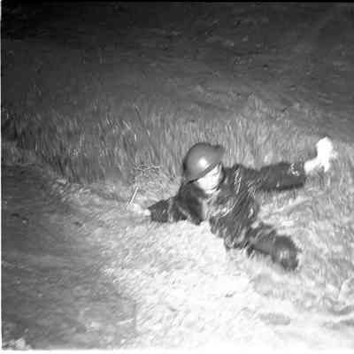 Soldier in flooded drainage ditch