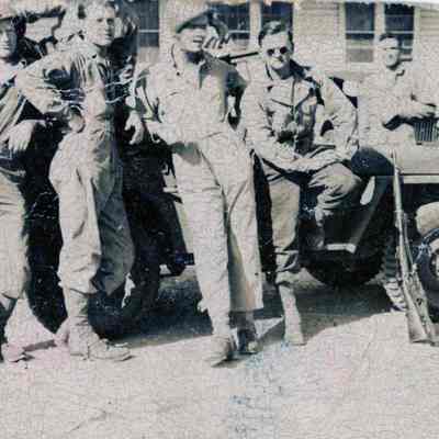 Soldiers posing in front of Jeep