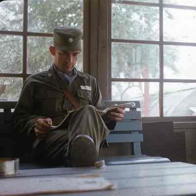 Soldier reading on a bench