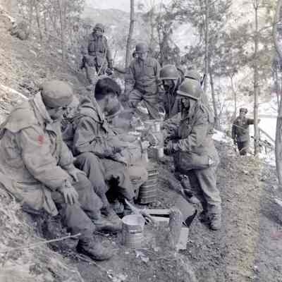 Soldiers lined up to enjoy a hot meal