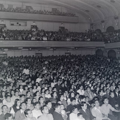 Large civilian audience in a theater