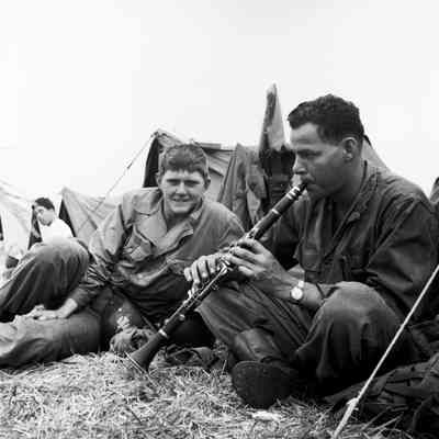 Soldier playing a clarinet in camp