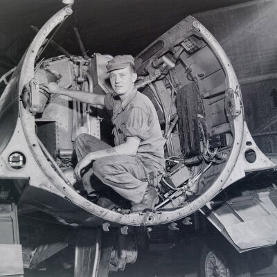 Air Force mechanic inside an aircraft fuselage