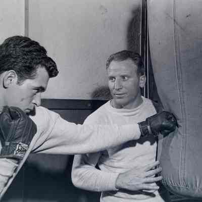 Boxer and trainer working a bag