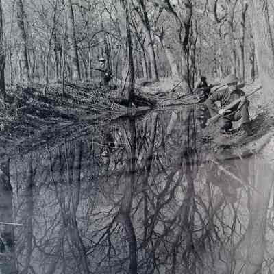 Soldiers taking cover in a creek