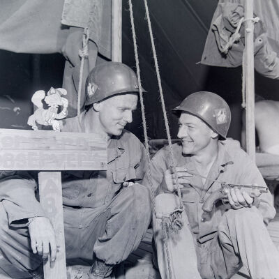 Two soldiers examining an antique pistol