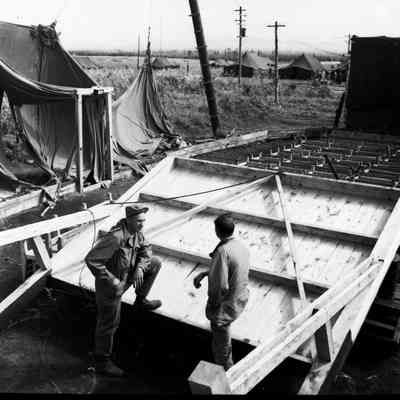 Soldiers talking next to a barracks building under construction